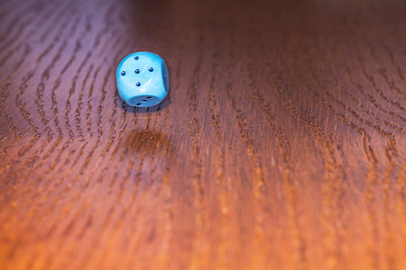 The dice roll on the wooden table. Role-playing game Dungeons and Dragons. Gambling in the casino.