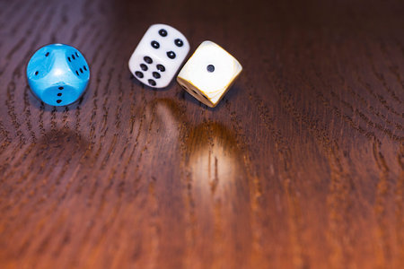 The dice roll on the wooden table. Role-playing game Dungeons and Dragons. Gambling in the casino.