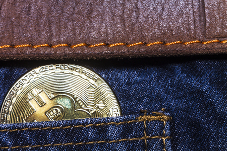Bitcoin blue jeans and brown leather beltの写真素材