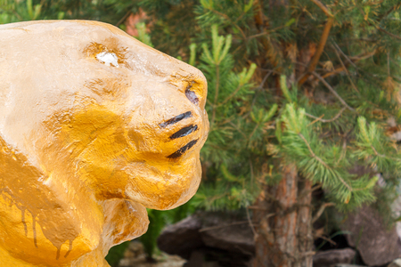 Lying decorative yellow lion as a home decoration and a symbol of luck, power and strength.の写真素材