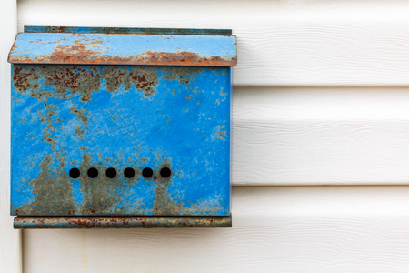A beautiful mailbox hangs waiting for newspapers, parcels and letters from friends.の写真素材
