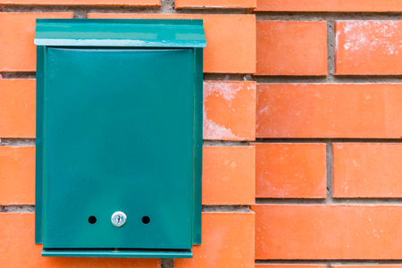 A beautiful mailbox hangs waiting for newspapers, parcels and letters from friends.の写真素材