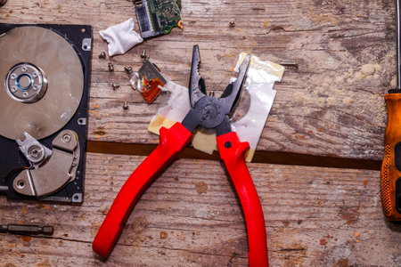 A man breaks a computer using locksmith tools. The concept of hacking, computer hacking and inept...