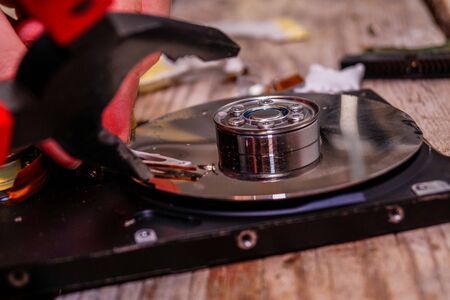 A man breaks a computer using locksmith tools. The concept of hacking, computer hacking and inept computer repair.の写真素材