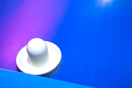 Bright and brilliant air hockey table with instruments for playing. Arcade for entertaining children.の写真素材