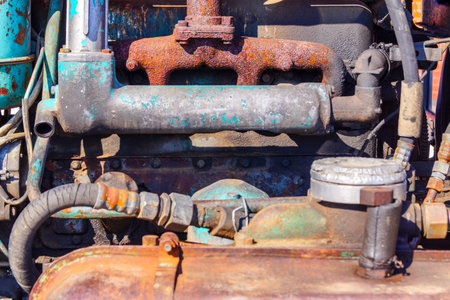 An old rusty tractor diesel engine needs repair and cleaning. Agreecultural machines.