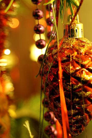 Bright and shiny decorations for Christmas and New Year hang on a green spruce. Winter holidays.の写真素材