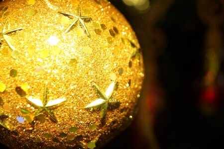 Bright and shiny decorations for Christmas and New Year hang on a green spruce. Winter holidays.の写真素材