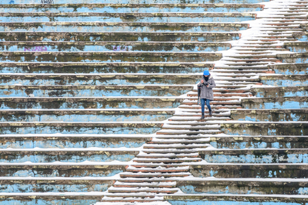 Bucharest, Romania - January 11: Tineretului Park Amphitheater on January 11, 2016 in Bucharest. Amphitheater background seats covered by snow and young woman in winter.のeditorial素材