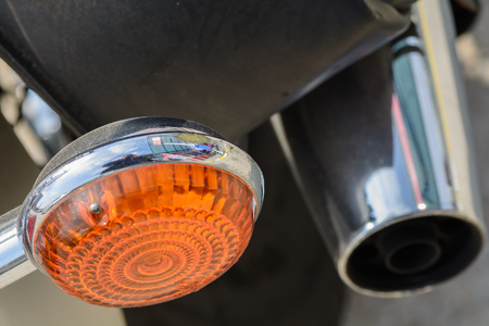 Closeup with bicycle components. Very modern bicycle with orange metal headlight taillight.の写真素材
