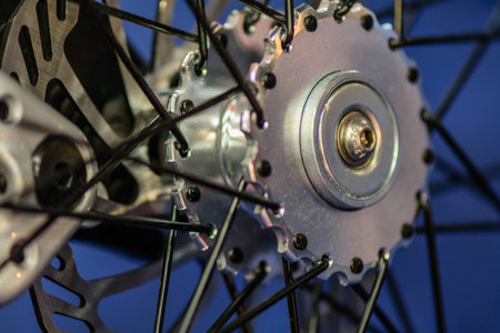 Studio shot with bicycle wheel. Close up detail with bicycle wheel over blue background.