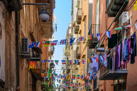 Naples (Napoli), Italy - June 11: Streets of Naples, June 11, 2016 in Naples, Italy. Many international small flags hanging from ropes along streets.のeditorial素材