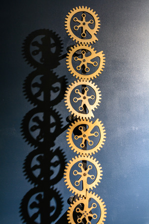 Industrial gears background. Industrial metal background with six gears and shadows over blue background.の写真素材