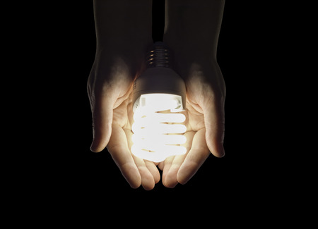 hands in the glow of fluorescent lightの写真素材
