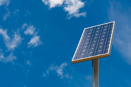 Solar panel against a blue sky with light clouds