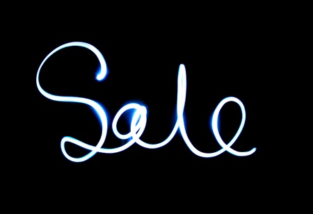 conflagrant inscription "sale" on a black backgroundの写真素材