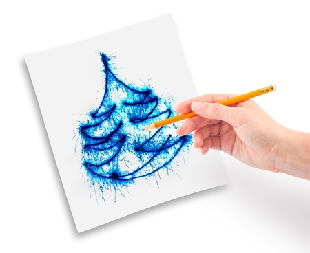 Womanish hand with a pencil in his hand draws a Christmas tree.の写真素材