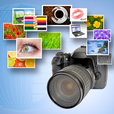 Digital camera and photographs against blue background and world mapの写真素材