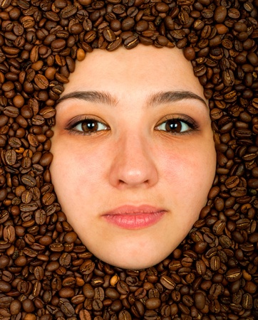 Coffee beans around of face beautiful young womanの写真素材