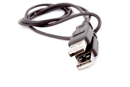 Single black USB-cable. Isolated on white background. Close-up. Studio photography.