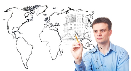 Businessman drawing a city of the future and the map of world on white backgroundの写真素材