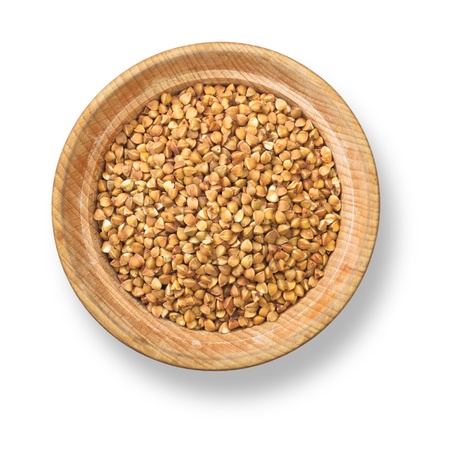 Buckwheat in wood plate with shadow isolated on white backgroundの写真素材