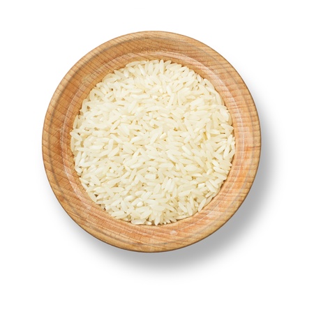 Rice in wood plate with shadow isolated on white backgroundの写真素材
