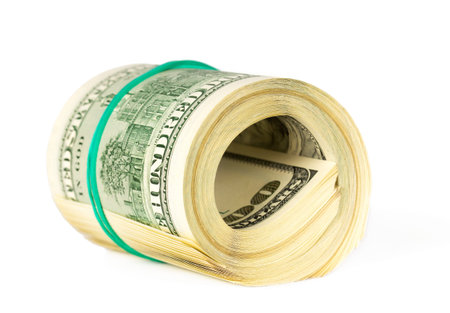 US dollars rolled up and tightened with band isolated on white background