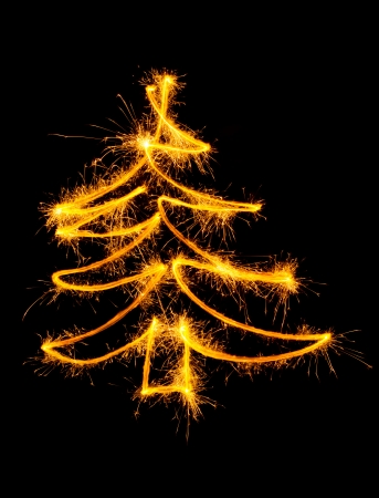 Christmas tree made by sparkler on a black backgroundの写真素材