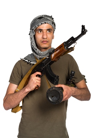 Terrorist Arab nationality in camouflage suit and keffiyeh with automatic gun and launcher on white backgroundの写真素材