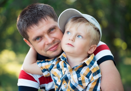 Happy father and his baby son having fun in the park outdoorの写真素材