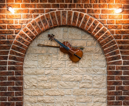 Element of the interior stone arch with a violin on a wallの写真素材
