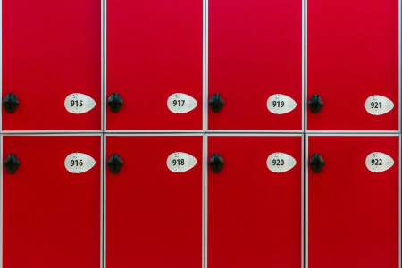 Red doors with numbers and locks in the locker roomの写真素材