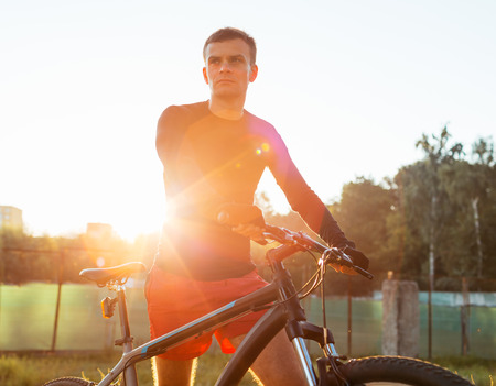 Mountain bike cyclist riding at sunrise healthy lifestyle active athlete doing sportの写真素材