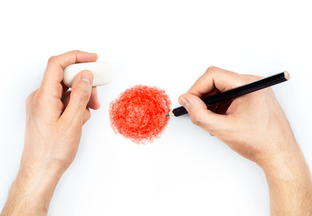Man's hands with pencil draws flag of Japan on white backgroundの写真素材
