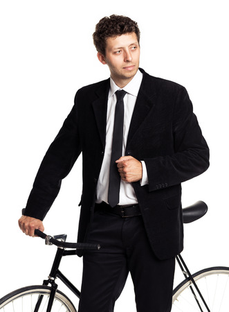 Attractive man in a classic suit with a bicycle on a white backgroundの写真素材