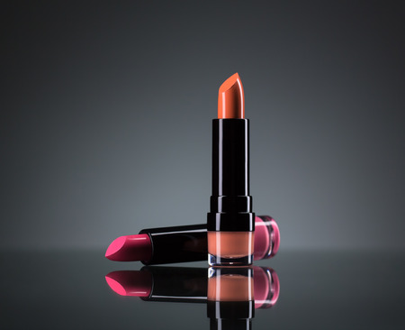 Two bright lipsticks on a black backgroundの写真素材
