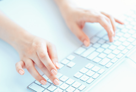 Female hands or woman office worker typing on the keyboardの写真素材
