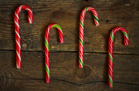 Candy canes on wooden boards - holidays backgroundの写真素材