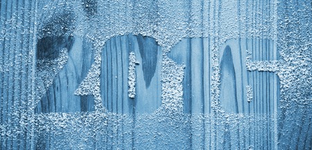 The inscription 2016 made with snow on the wooden background. Winter holidays backgroundの写真素材