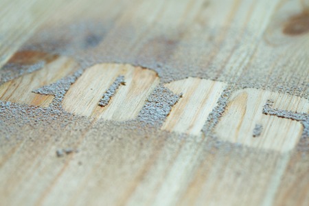 The inscription 2016 made with snow on the wooden background. Winter holidays backgroundの写真素材