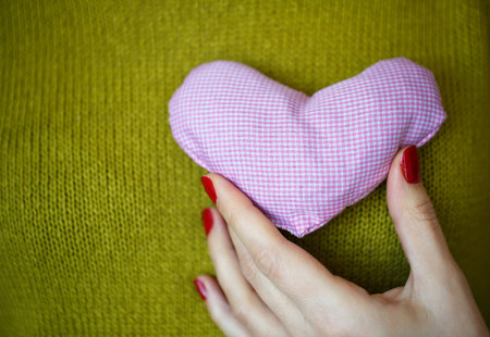 Closeup on pink heart in hand of woman. Image of Valentines day
