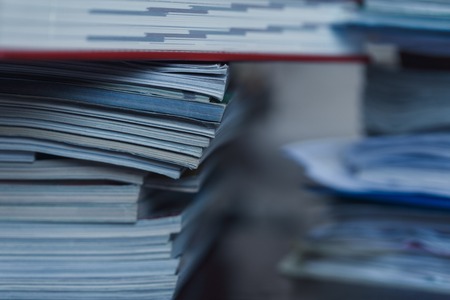 Accounting and taxes. Large pile of magazine, notebook and books closeupの写真素材
