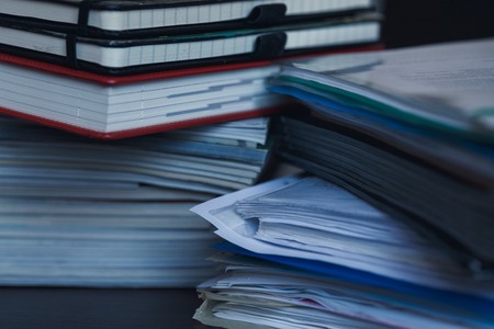 Accounting and taxes. Large pile of magazine, notebook and books closeupの写真素材