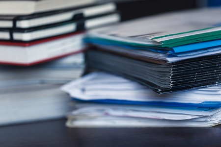 Accounting and taxes. Large pile of magazine, notebook and books closeupの写真素材