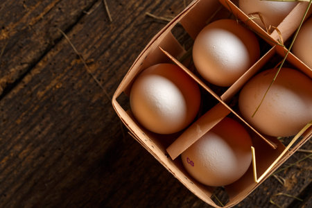 Fresh chicken eggs on a wooden rustic background