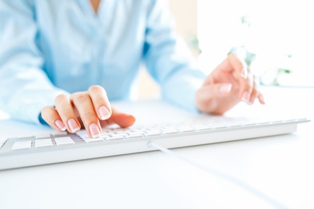 Female hands or woman office worker typing on the keyboardの写真素材