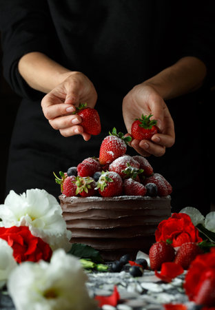 Ripe strawberries in a chocolate cake on a black backgroundの写真素材