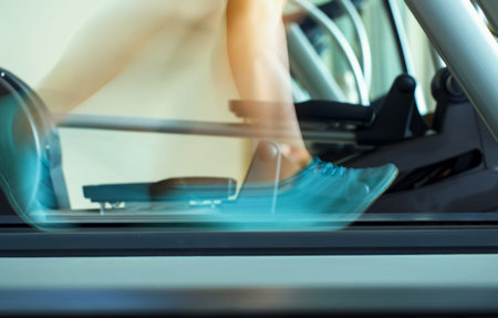 Foot of woman running on treadmill in gym