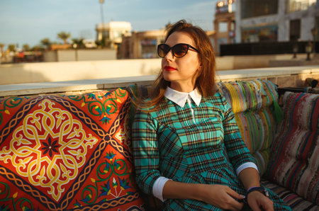 Beautiful young woman relaxes in a cafe in Egypt
